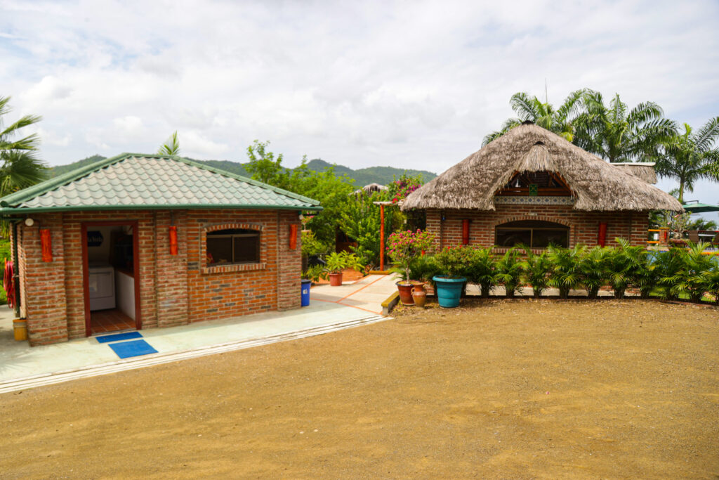 The laundry/storage building (left), the pool equipment room (right) and the parking area.