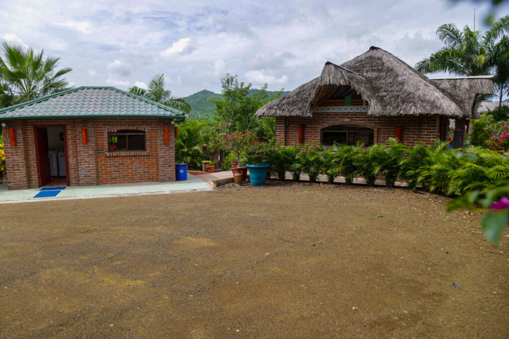 The laundry/storage building (left), the pool equipment room (right) and the parking area.